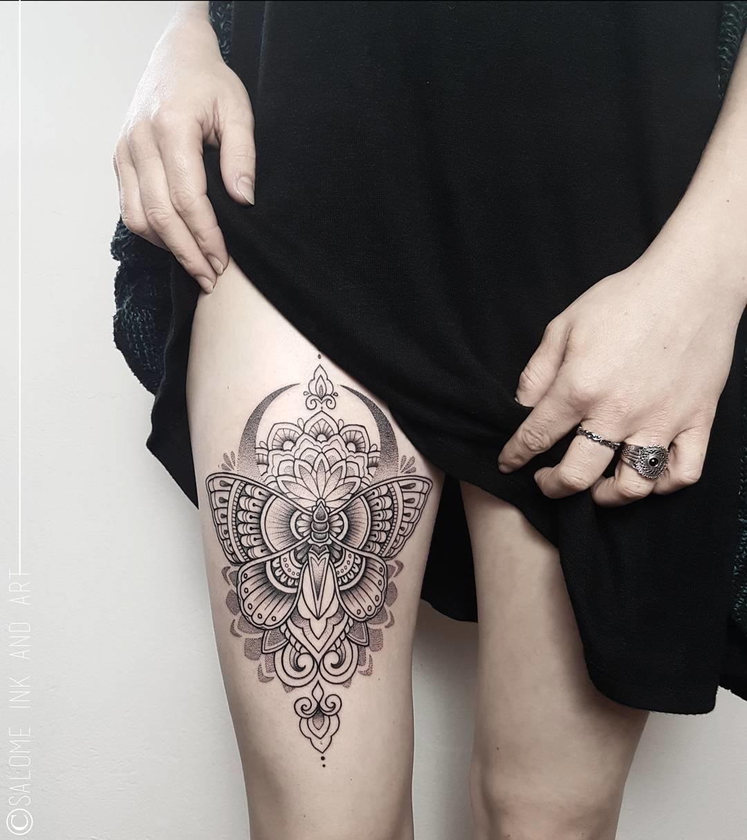 Tattoo de mariposa y mandala en la pierna